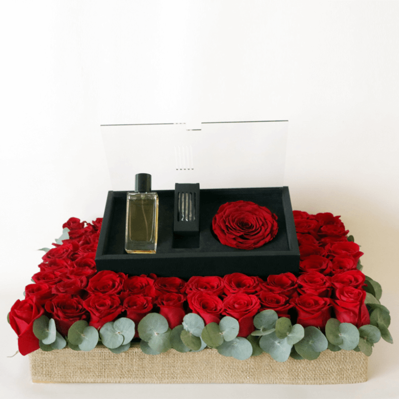 Revealing Red Always_1 revealing red perfume arranged on filling with red roses and eucalyptus