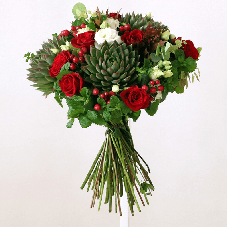 Red and green bouquet with succulents red rose, red hypericum, mint, succulents and white eustoma in a bouquet