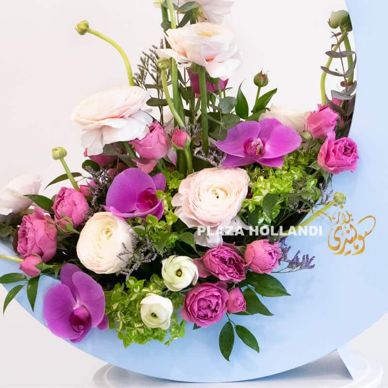 Moon A 2 Close up of phalaenopsis orchids, ranunculus flowers and spray roses