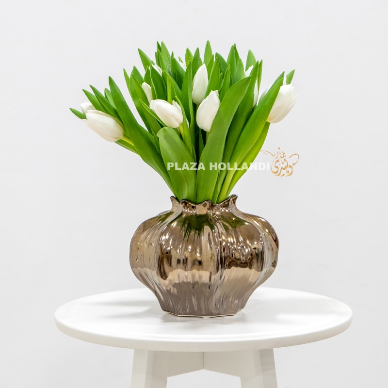 5 white tulips in a brass vase